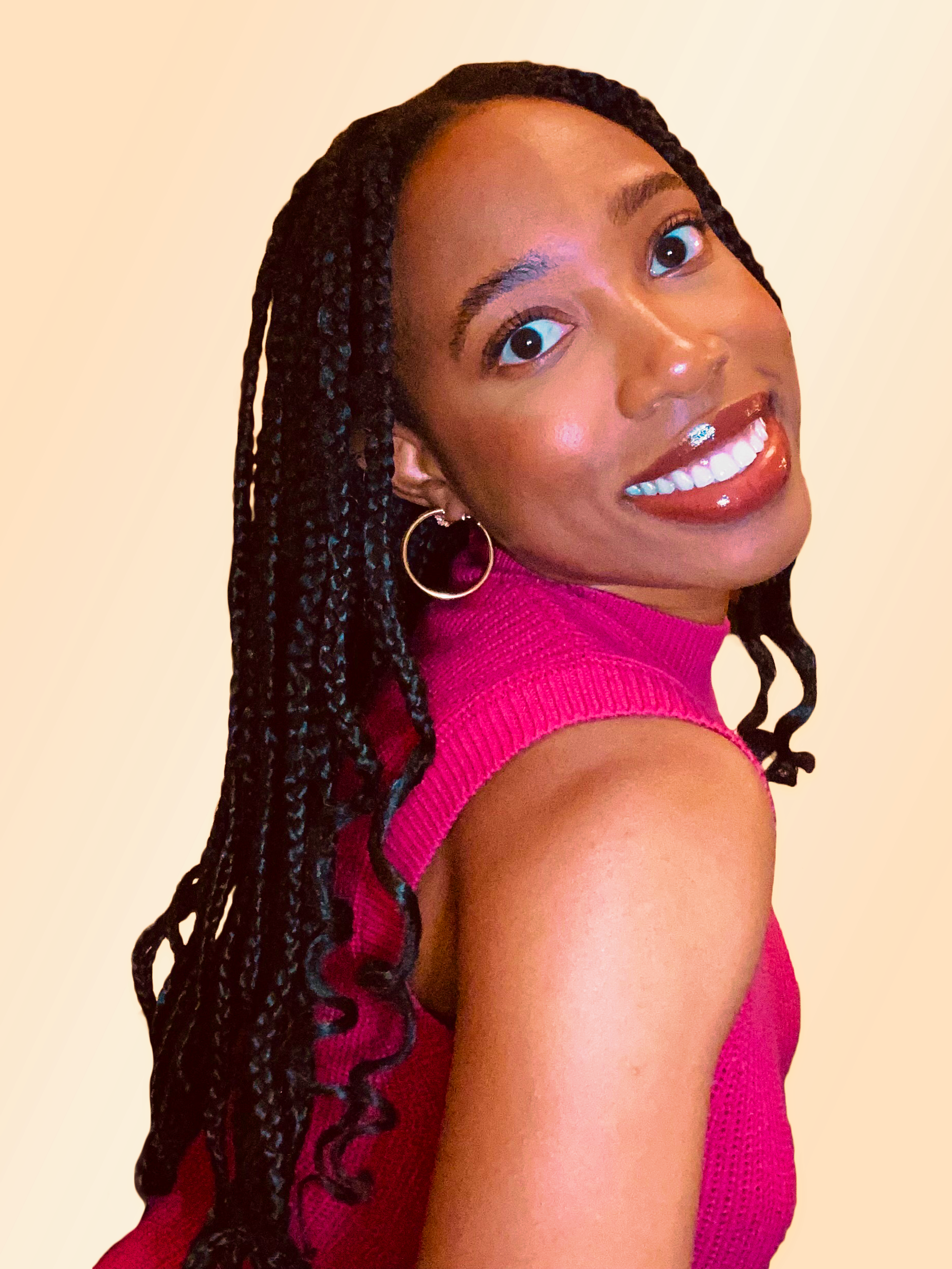 portrait of body pH Founder Paij, who has black braided hair, is wearing hoop earrings and a bright pink sleeveless jumper.