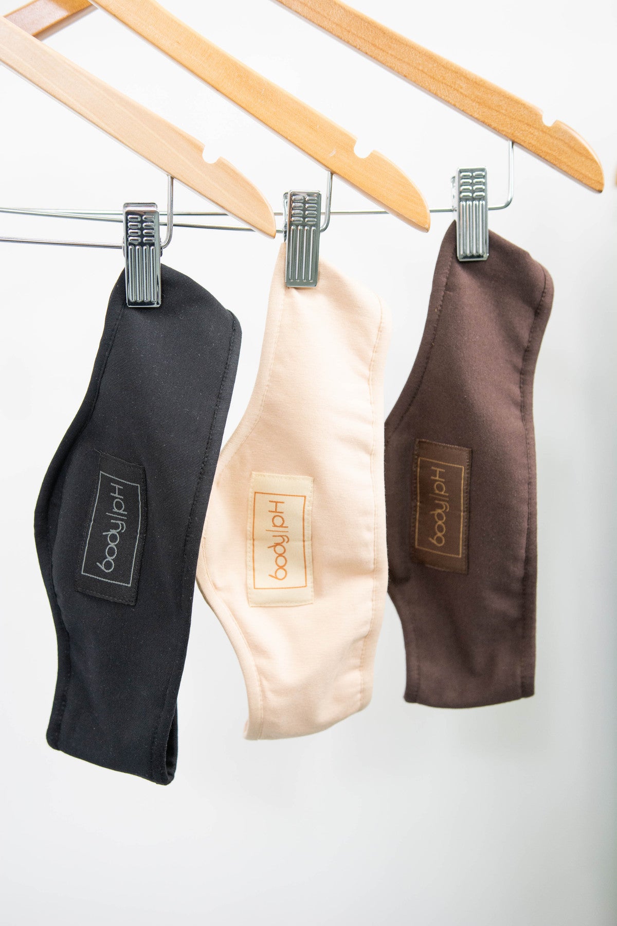 The cotton bra liners in three colours: black, beige, and brown with the body pH logo on them